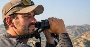 Man with binoculars on a ridge