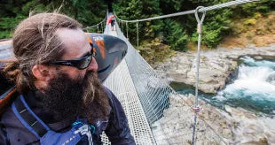 Man on a bridge crossing over a river