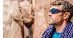 A rock climber wearing Wiley X Sunglasses