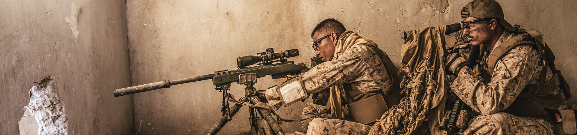 Two soldiers looking out wearing Wiley X protective eyewear. 