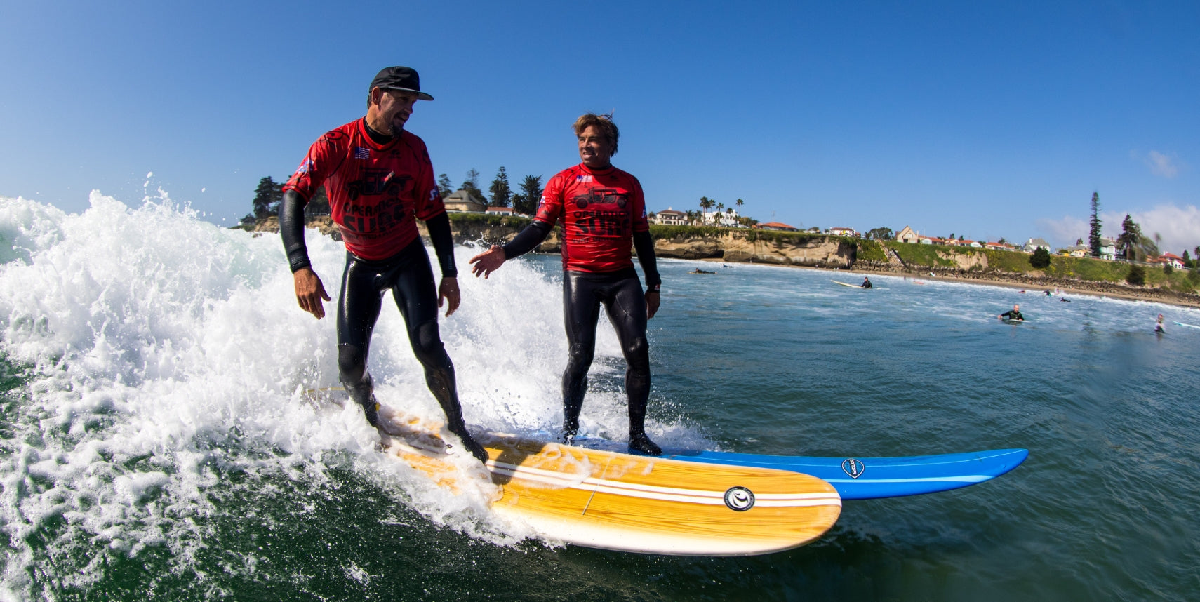 Operation Surf attendees surfing side by side